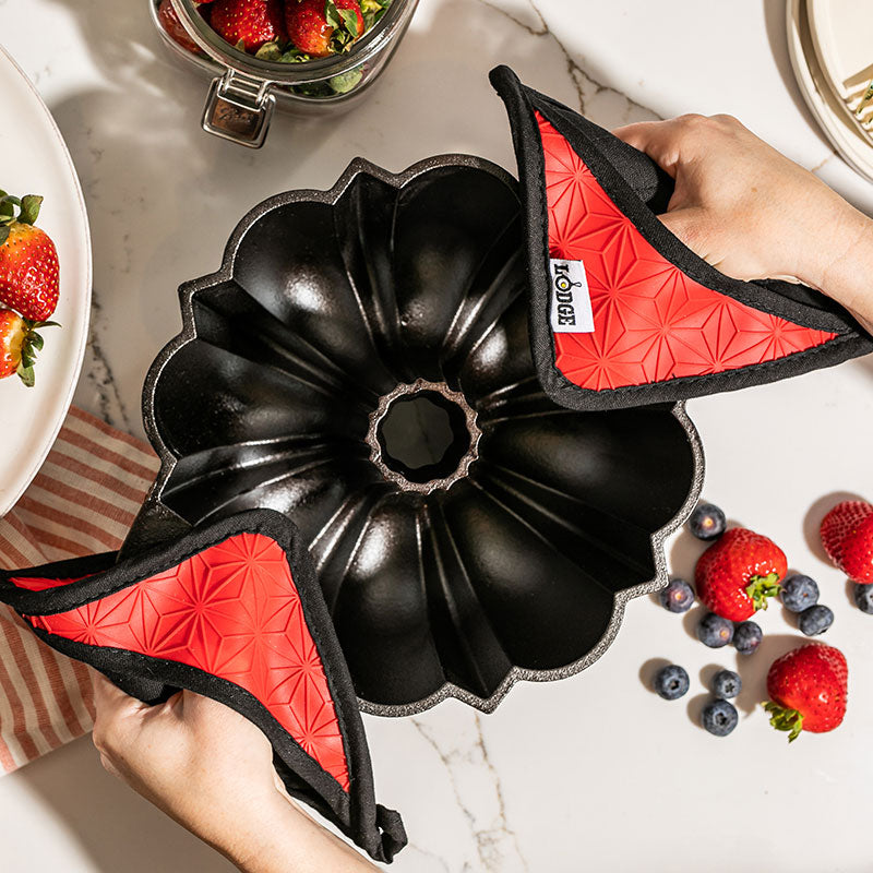Cast Iron Fluted Cake Pan with Red Potholders - Lodge
